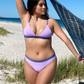Sustainable swimwear reversible bikini top in blue and purple on the beach