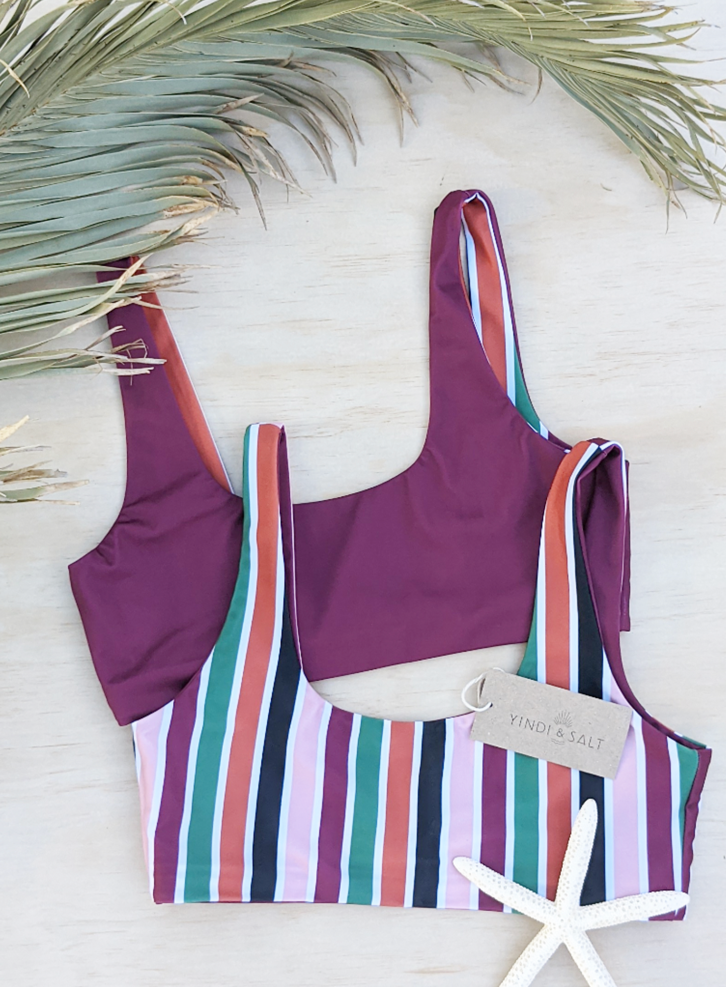Sustainable swimwear reversible bikini top in wine and stripe flat lay