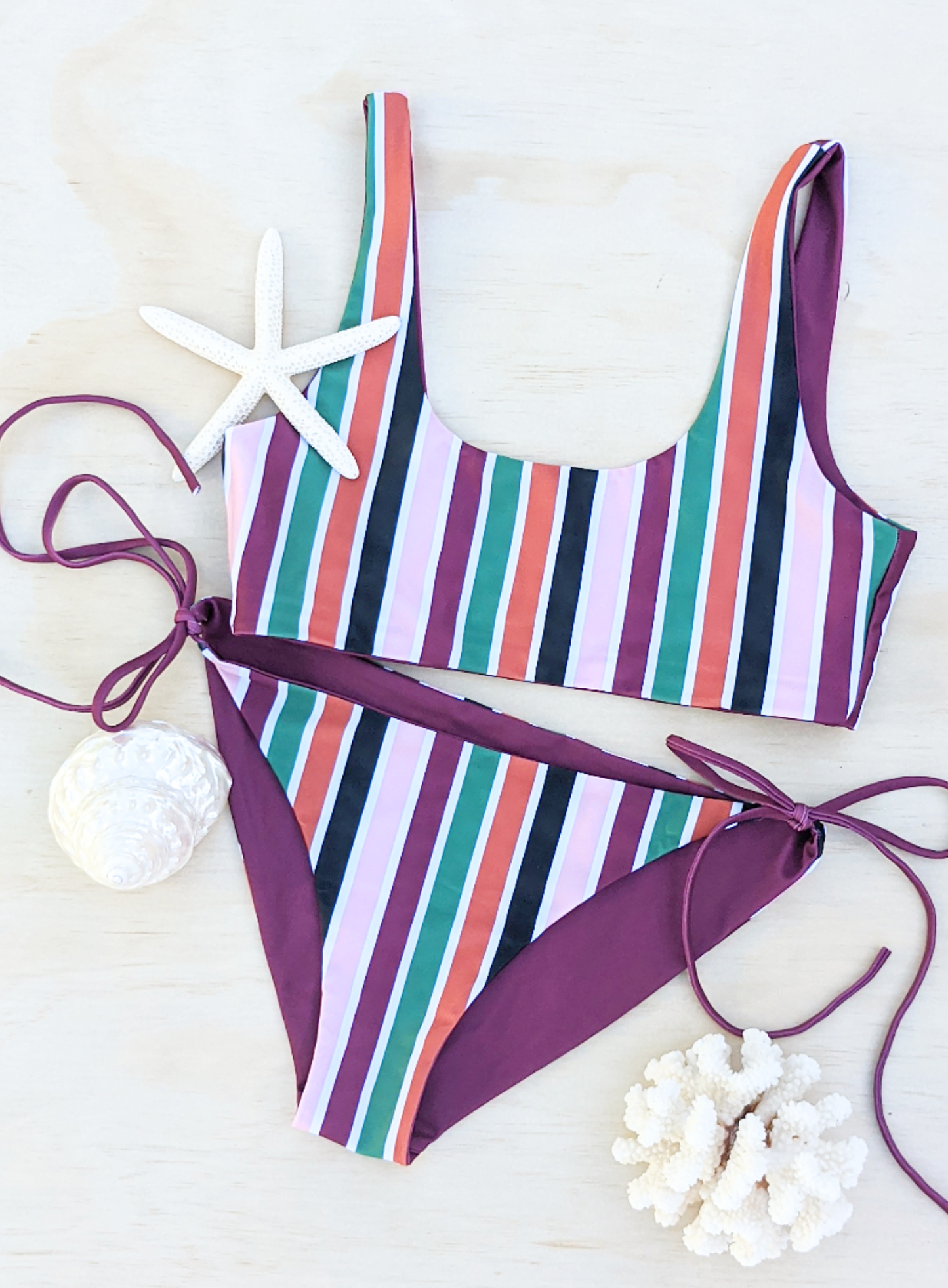 Sustainable swimwear reversible bikini  tie side classic cut bikini bottom in wine and stripe flat lay