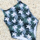 Sustainable swimsuit One Piece Swimwear with a Blue Floral Print, Thin Straps Classic Cut And High Cut Leg flat lay