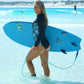 Long sleeved black sustainable surf suit with back zip and floral side panel detail in the water