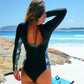 Long sleeved black sustainable surf suit with back zip and floral side panel detail back view