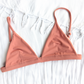 Sustainable swimwear reversible bikini top in blush and peach flat lay blush side