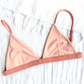 Sustainable swimwear reversible bikini top in blush and peach flat lay peach side