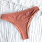 Sustainable swimwear reversible bikini in blush and peach cheeky bikini bottom flat lay