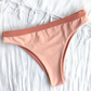 Sustainable swimwear reversible bikini in blush and peach cheeky bikini bottom flat lay peach side