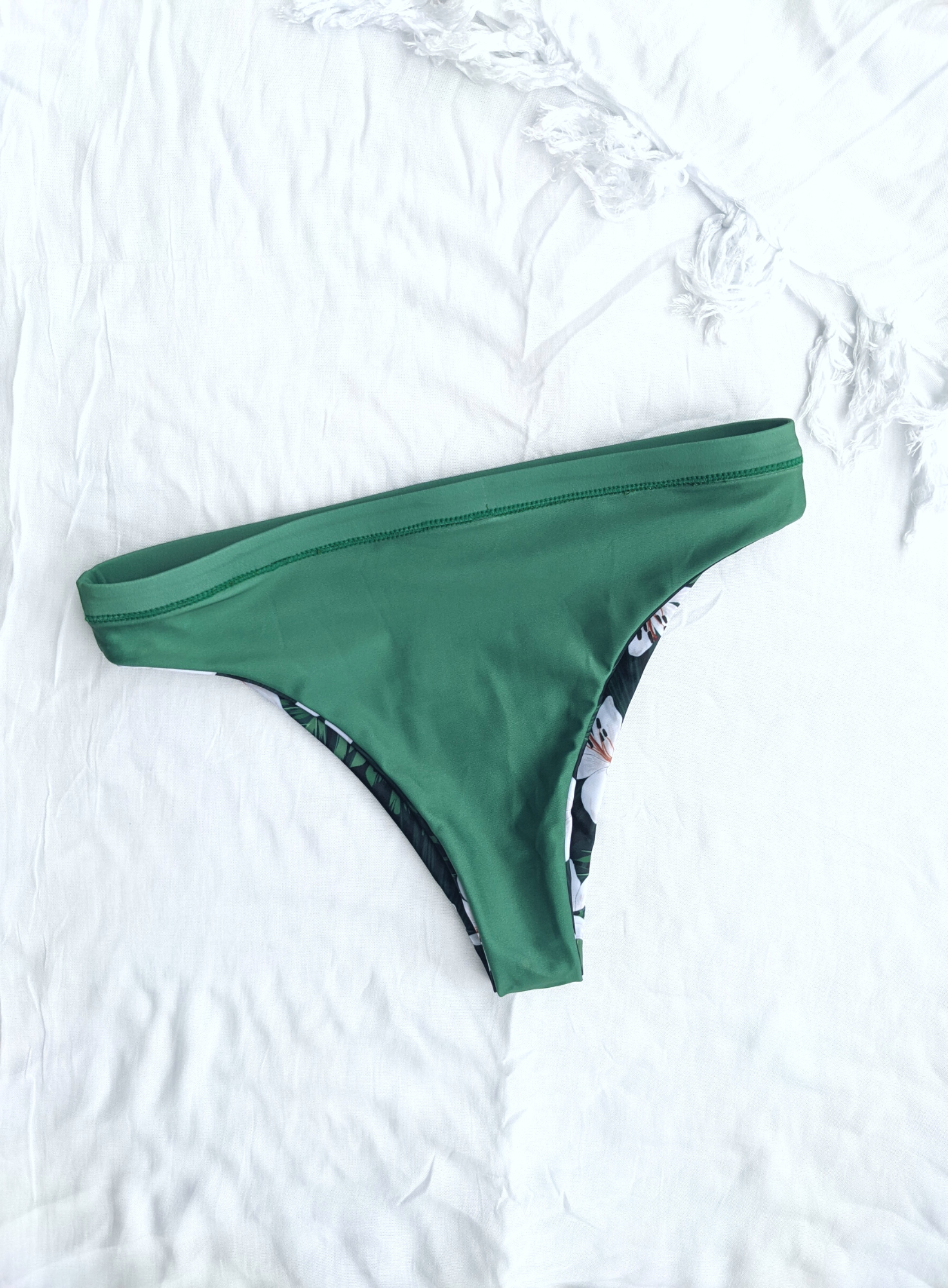 Sustainable swimwear reversible bikini green floral cheeky bikini bottom flat lay green side