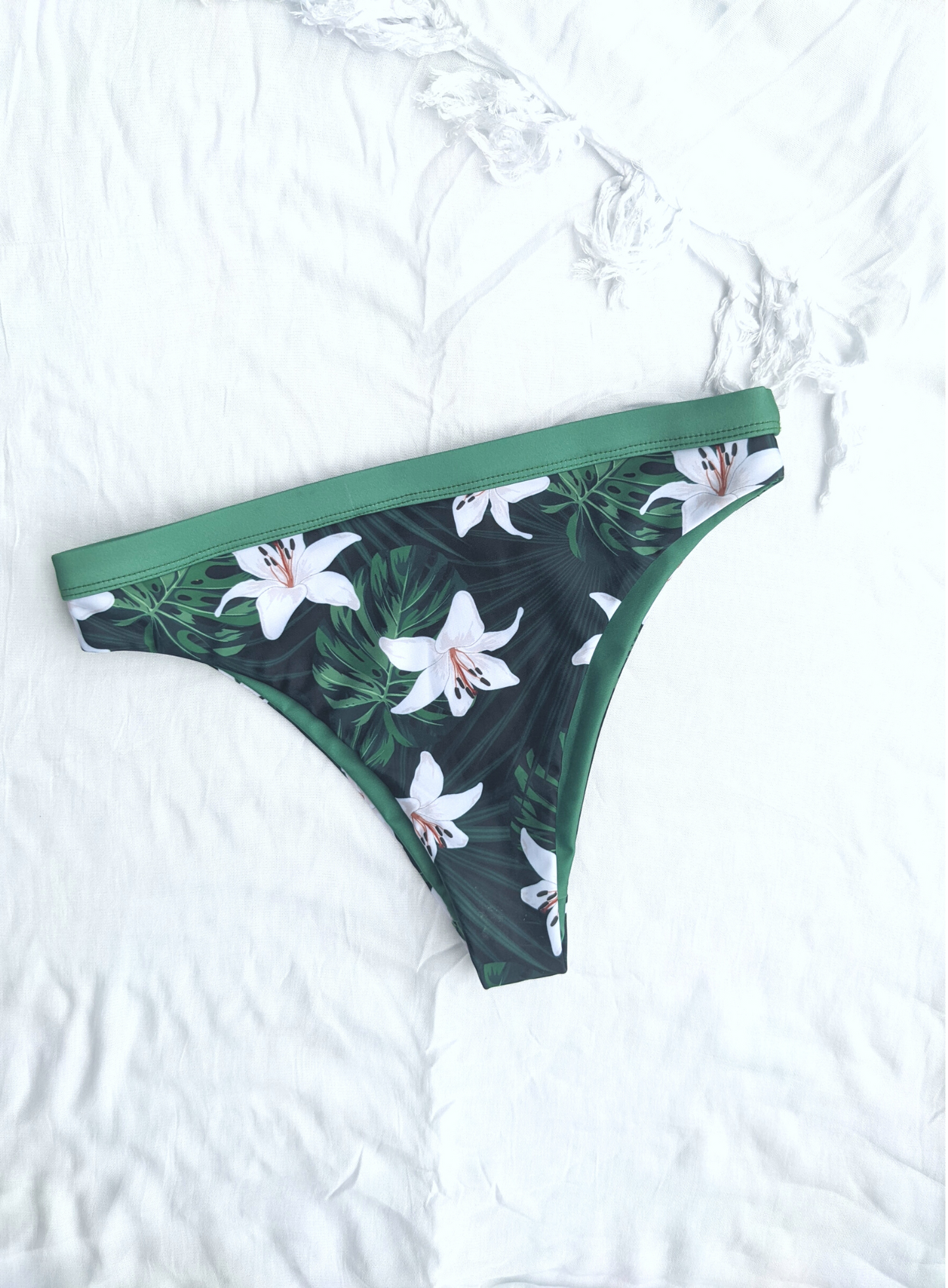 Sustainable swimwear reversible bikini green floral cheeky bikini bottom flat lay