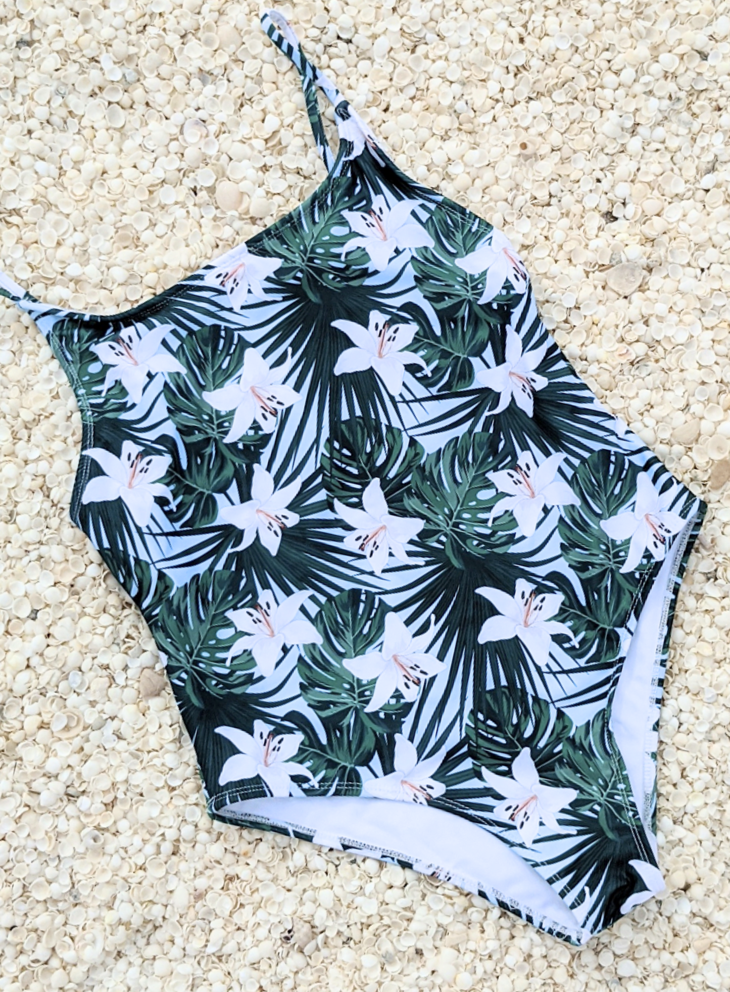 Floral print one piece swimwear made from sustainable swimwear material, flat lay