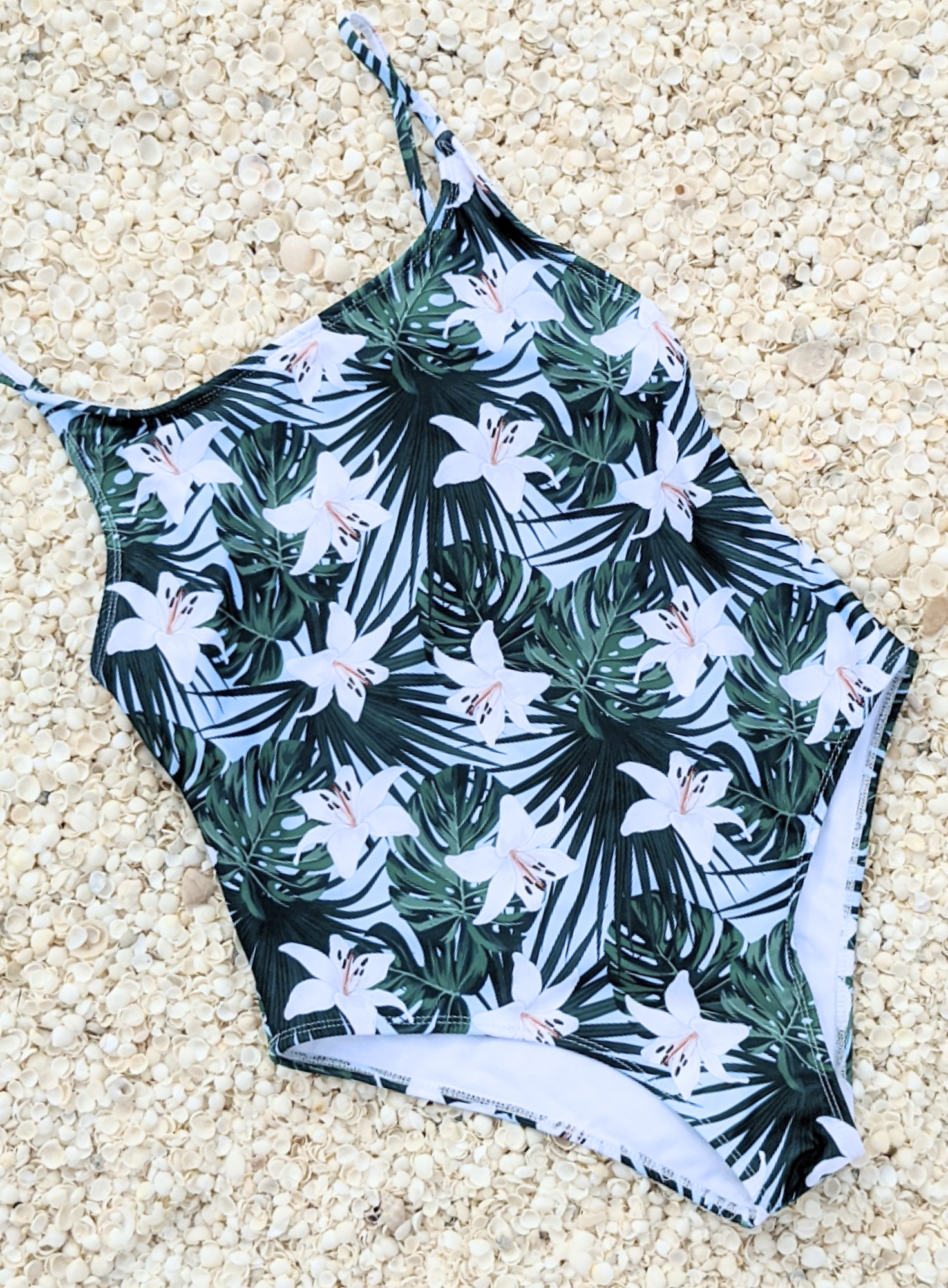 Floral print one piece swimwear made from sustainable swimwear material, flat lay