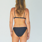 Reversible bikini consisting of black bikini top and cheeky bikini bottom made from sustainable swimwear material, back view