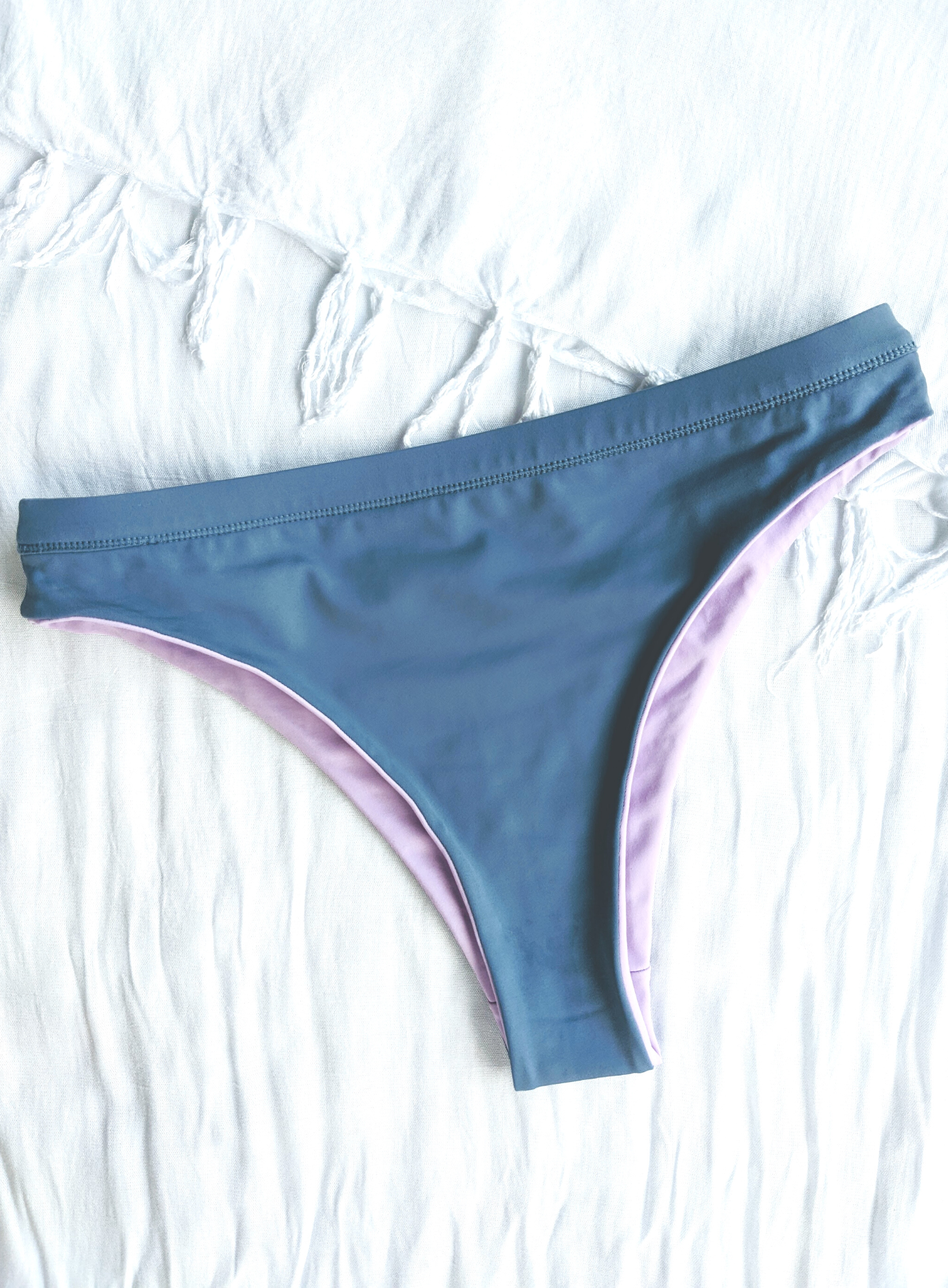 Reversible Blue and Lilac Medium High Cut Bikini Bottom Made From Eco Friendly Recycled Regenerated Fabric Blue Front Flat Lay View