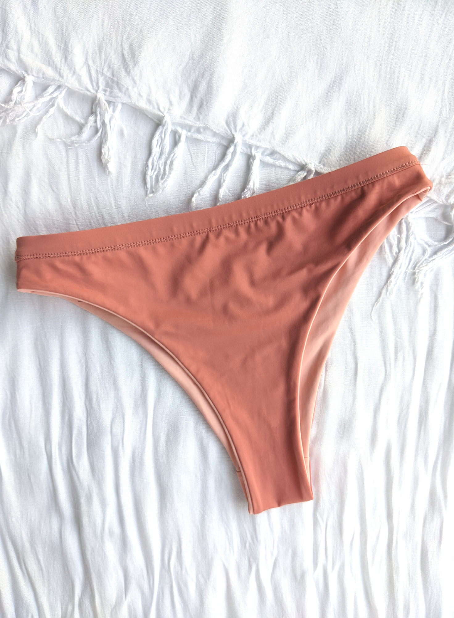 Sustainable reversible blush and peach cheeky bikini bottom