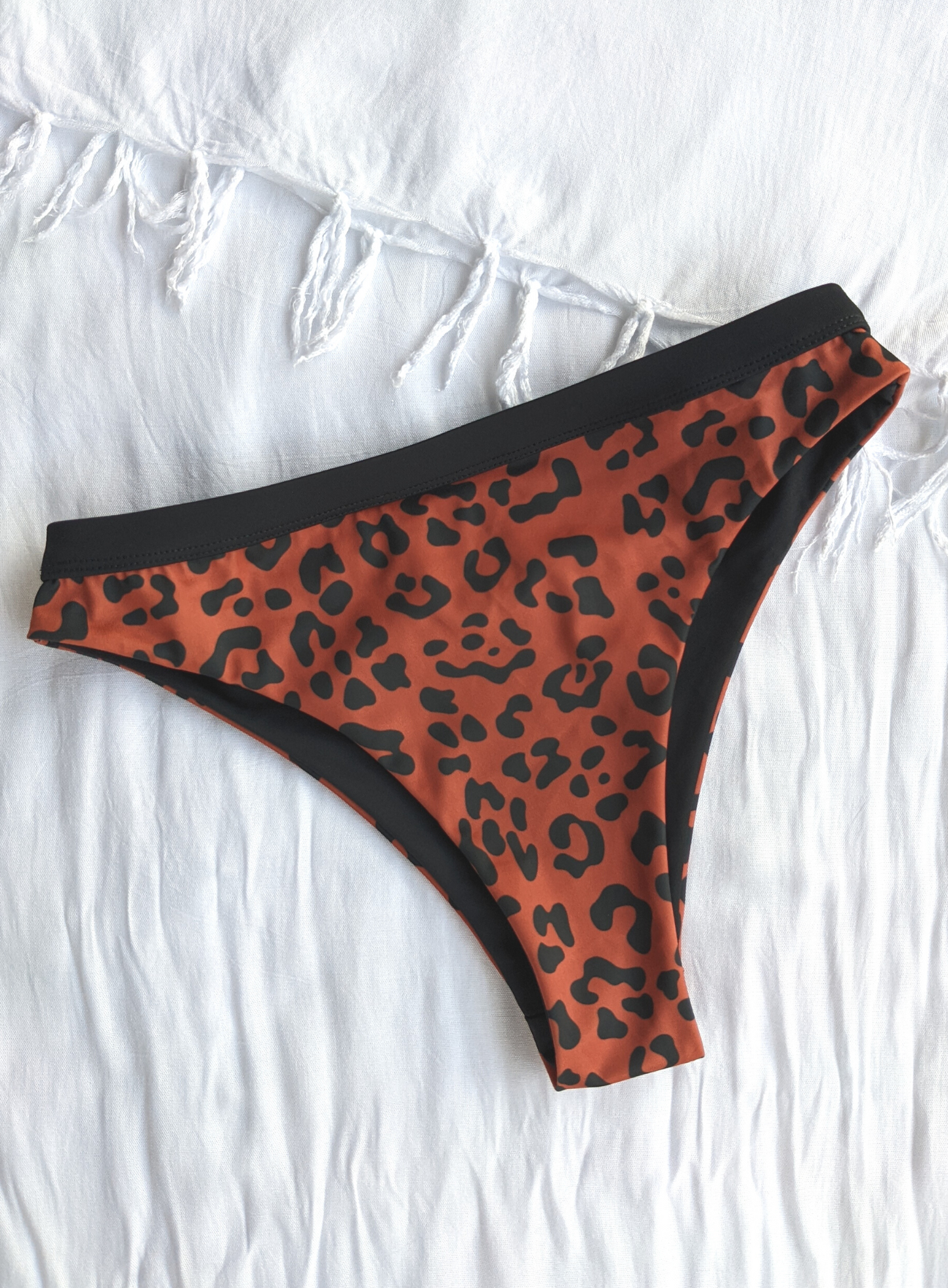 Reversible Black and Leopard Print Medium High Cut Bikini Bottom Made From Eco Friendly Recycled Regenerated Fabric Leopard Front Flat Lay View