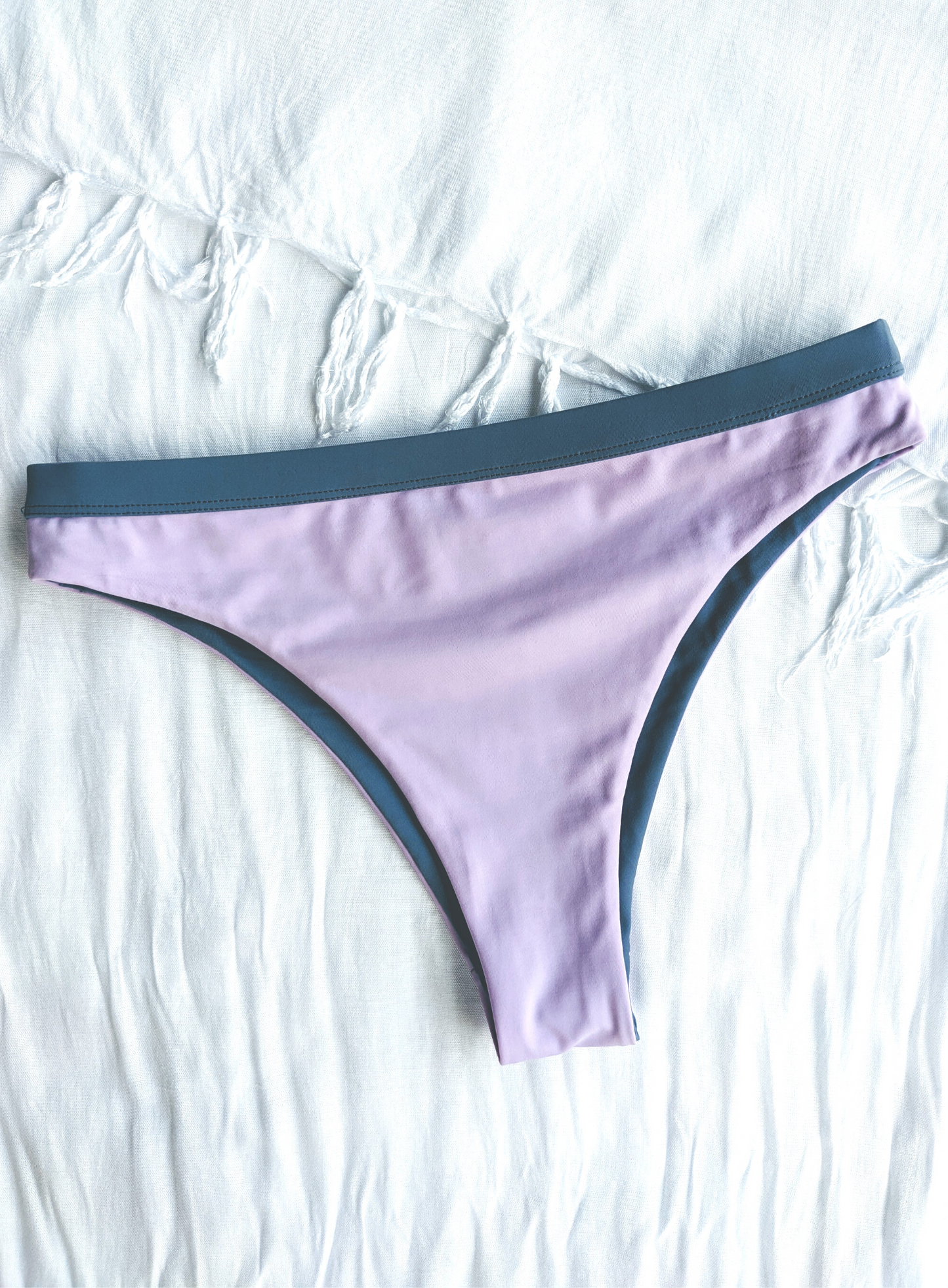 Reversible Blue and Lilac Medium High Cut Bikini Bottom Made From Eco Friendly Recycled Regenerated Fabric Lilac Front Flat Lay View